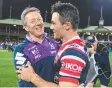  ??  ?? Storm coach Craig Bellamy congratula­tes Cooper Cronk.