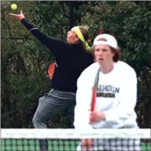  ?? LARRY GREESON / For the Calhoun Times ?? Calhoun’s Matthew Turner (left) serves while his doubles partner Aaron Lively waits at the net.