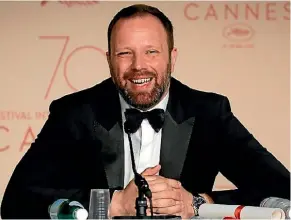  ??  ?? Yorgos Lanthimos celebrates winning the award for best screenplay at this year’s Cannes Film Festival.