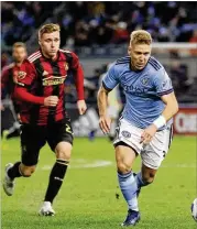  ?? STEVE LUCIANO / AP ?? New York City FC defender Anton Tinnerholm (right) moves the ball away from Atlanta United midfielder Julian Gressel during the second half of their MLS playoff match this past Sunday.