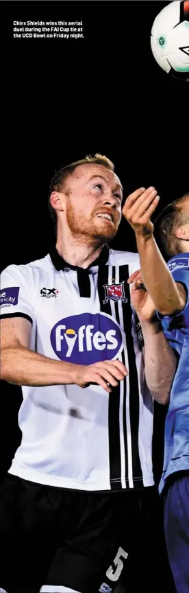  ??  ?? Chirs Shields wins this aerial duel during the FAI Cup tie at the UCD Bowl on Friday night.