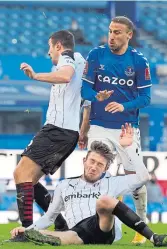  ??  ?? Everton’s Cenk Tosun and Rotherham’s Angus Macdonald battle for the ball