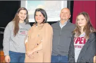  ?? KATIE SMITH/THE GUARDIAN ?? Following a public meeting at the Milton Community Hall Meaghan, Lori, Gordie and Ellie Kirkpatric­k, who hope to get approval to be able to build an equestrian residentia­l community in Ebenezer stand in front of a concept photo of what the community...