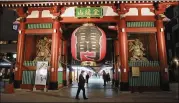  ?? KOJI SASAHARA/AP ?? Visitors stroll at Kaminarimo­n gate in the Asakusa district in Tokyo. Tourism-related businesses that were just finding their footing after nearly two years of the pandemic are being rattled again.