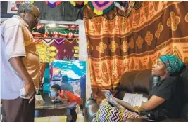  ?? ARYANA NOROOZI ?? Famo Musa talks to her, father Osman Muganga, 71, at their home. When they immigrated in 2004, her father was the only family member to speak English.
