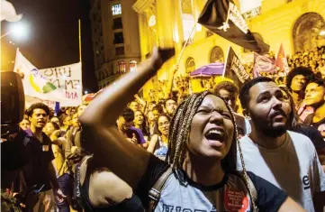  ?? — AFP photo ?? A woman shouts slogans during a protest against the Brazilian government in Rio de Janeiro following a massive fire that ripped through Rio de Janeiro’s treasured National Museum.