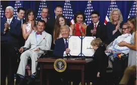  ?? (Leah Millis/Reuters) ?? US PRESIDENT Donald Trump shows off the signed ‘Right to Try’ act at the White House last month.