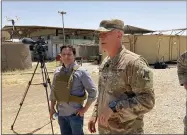  ?? LOLITA BALDOR—ASSOCIATED PRESS ?? In this May 21, 2021, photo Col. Scott Desormeaux, who is with the Louisiana National Guard, talks to reporters in northern Syria during a visit by Marine Gen. Frank Mckenzie, top U.S. commander for the Middle East. The Syria deployment is just one of many missions the Louisiana Guard had to juggle over the past year. Listening at left is ABC correspond­ent Luis Martinez.