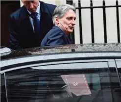  ?? —AFP ?? LONDON: This file photo taken on January 31, 2017 shows British Chancellor of the Exchequer, Philip Hammond leaving Downing street after the weekly cabinet meeting in central London.