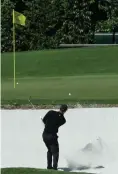  ?? Associated Press ?? ■ Tiger Woods hits from a bunker on the fourth hole during the first round at the Masters golf tournament Thursday in Augusta, Ga.