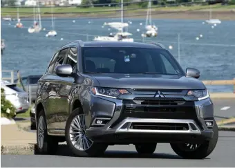  ?? JIM MAHONEY / HERALD STAFF ?? QUIET PERFORMER: The 2019 Mitsubishi Outlander PHEV’s electric motors turn the front and back wheels while the gas engine charges the battery.