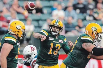  ?? JASON FRANSON THE CANADIAN PRESS ?? Eskimos quarterbac­k Mike Reilly (13) makes a throw against the Montreal Alouettes in first-half CFL action in Edmonton on Saturday. Reilly surpassed 25,000 career passing yards in a 40-24 Eskimos victory.