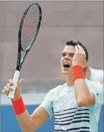  ?? AP PHOTO ?? Milos Raonic reacts after a point by Ryan Harrison during their secondroun­d match of the U.S. Open tennis tournament Wednesday in New York. Harrison upset the No. 5-ranked Raonic in four sets.