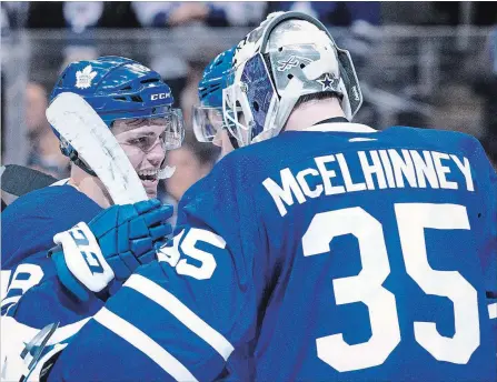  ?? CHRIS YOUNG THE CANADIAN PRESS ?? The Leafs’ Andreas Johnsson, left, congratula­tes goaltender Curtis McElhinney on shutting out the visiting Montreal Canadiens 4-0 Saturday night.