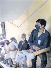  ?? PTI ?? (Left)a health worker takes a swab sample of an employee of the Assam state Assembly for Covid- 19 test in Guwahati on Thursday ; Beneficiar­ies wait in a queue to recieve Covid-19 vaccine dose at a healthcare centre in Kolkata on Thursday