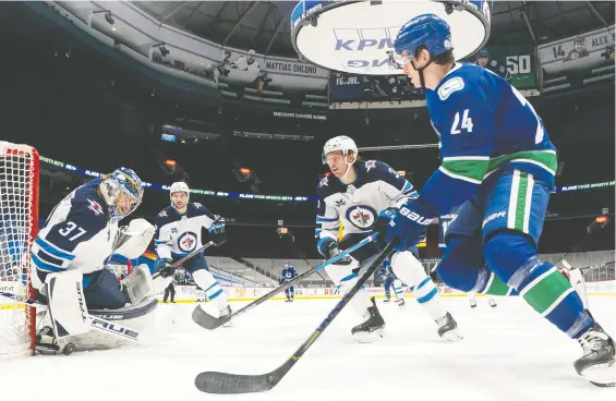  ?? RICH LAM/GETTY IMAGES FILES ?? Former Winnipeg Jet Tucker Poolman, centre, has earned a reputation as a steady defender, which landed him a $10-million free-agent deal with the Canucks.