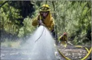  ?? PAUL KITAGAKI JR./THE SACRAMENTO BEE VIA AP ?? Fire crews battle the Pawnee Fire on Cache Creek Road on Monday in Spring Valley, Calif. Thousands were forced to flee their homes Monday as major wildfires encroached on a charred area of Northern California still recovering from severe blazes in...