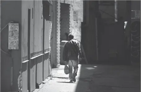  ?? PHOTOS: DAX MELMER ?? A man leaves the alley behind the Pelissier Street parking garage after smoking crystal meth. “It’s everywhere,” one addict says.