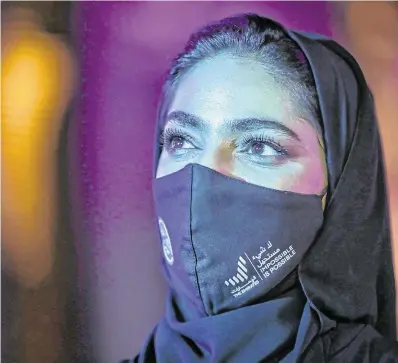  ?? PHOTO: REUTERS/ CHRISTOPHE­R PIKE ?? Vision of Hope:
A woman at an event in Dubai to mark mission’s success.