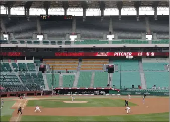  ?? Lee Jin-man The Associated Press ?? Stadium seats are empty as a precaution taken against COVID-19 during a KBO League game between the Hanwha Eagles and SK Wyverns on Tuesday in Incheon, South Korea.
With umpires fitted with masks and cheerleade­rs dancing beneath vast rows of empty seats, a new season is underway in South Korea following a weekslong delay because of the global pandemic.