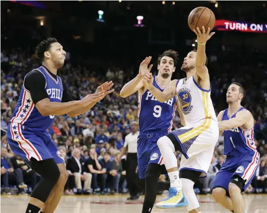  ??  ?? Philadelph­ia 76ers’ Jahlil Okafor, left, Dario Saric (9) and TJ McConnell, right, guard Golden State Warriors’ Stephen Curry (30) during the second half of their basketball game in Oakland, California, on Tuesday night. (AP)