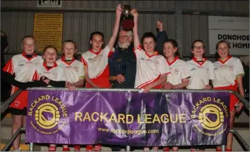  ??  ?? Joint captains Thomasina Carter and Neassa Ní Lúasaigh raise the cup presented by Kevin Waters.