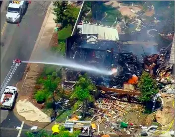  ?? Cbs-La VIa aP ?? This image from video provided by CBS-LA shows the aftermath of an explosion that destroyed a house Murrieta, Calif., sending up thick flames and closing several streets, on Monday. One Southern California Gas Company employee was killed.