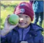  ??  ?? Rupert Elementary School kindergart­ner Kayvion Reinert-Cotton seems pretty happy with the apple he picked during an Oct. 25 field trip to Frecon Farms.