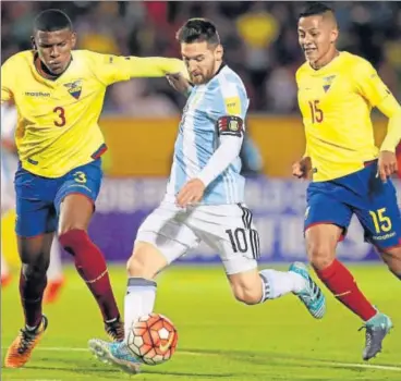  ?? REUTERS ?? Lionel Messi scores his third goal under pressure from Ecuador's Robert Arboleda (left) and Jefferson Intriago (right).