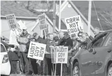  ?? DAVID JALA/CAPE BRETON POST ?? These protesters, shown here waving at vehicles on Prince Street, were among an estimated 600 people who turned out for June 2018 rally in front of Sydney’s provincial building. The rally, organized by Nova Scotians for Equalizati­on Fairness, was held to send a message to the provincial government that Cape Breton wants its fair share of the federal equalizati­on transfer payment that Nova Scotia receives each year.