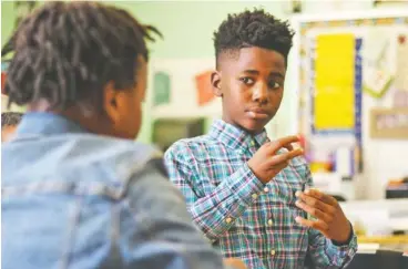  ?? STAFF PHOTO BY DAN HENRY ?? Sh’Quaveon Wells, left, works with La’michael Porter in Susan Dorsa’s fourth-grade class as students learned about plant cell structure.