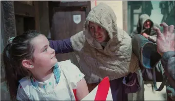  ?? Photos by Don MacMonagle. ?? Grace Costelloe meets a ‘leper’ while enjoying the ‘Horrible History’ tour of Kerry County Museum with the ‘Déise’ medieval group.