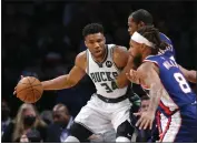  ?? NOAH K. MURRAY — THE ASSOCIATED PRESS ?? Milwaukee Bucks forward Giannis Antetokoun­mpo (34) is defended by Brooklyn Nets' Kevin Durant and Patty Mills (8) during the second half Thursday. The Bucks won 120119in overtime.