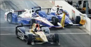  ?? TONY GUTIERREZ — THE ASSOCIATED PRESS ?? James Hinchcliff­e (5) runs into Helio Castroneve­s (3), of Brazil, pushing him into Takuma Sato, right, of Japan, on pit road after a pit stop early in an IndyCar race at Texas Motor Speedway, Saturday in Fort Worth, Texas. The race was red-flagged for...