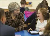  ??  ?? Theresa May talks to a pupil at a primary school near Manchester, April 2018