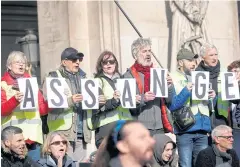  ??  ?? SUPPORTING THEIR MAN: Protesters hold signs demanding freedom for Wikileaks founder Julian Assange in front of the Opera Garnier in Paris last week.