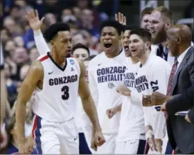  ?? TONY AVELAR — THE ASSOCIATED PRESS ?? Gonzaga forward Johnathan Williams (3) celebrates with teammates after dunking against Xavier during the second half of a Sweet 16 game Saturday. Gonzaga won 83-59.