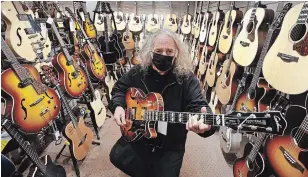  ?? CLIFFORD SKARSTEDT EXAMINER ?? Guitar Boutique owner Nick Angelo plays one of his many guitars on display at his store on Saturday at the Ranch Resort Banquet and Conference Centre near Bethany. Music store sales have increased due to the COVID-19 pandemic.