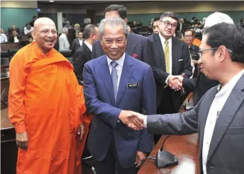  ?? — Bernama photo ?? Muhyiddin (second left) greets participan­ts after delivering his speech at the Internatio­nal Seminar on Religious Values in Preventing & Countering Violent Extremism at IIUM, Gombak.