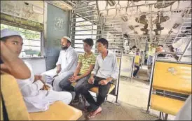  ?? ARUN SHARMA/HT ?? Junaid Khan’s brothers travel in the local train in which the 16yearold was lynched. The mood in the compartmen­t turns grim when someone mentions the teenager’s killing.