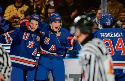  ?? ADAM IHSE/GETTY ?? Will Smith (center) celebrates with BU’s Lane Hutson and BC teammate Gabe Perreault.