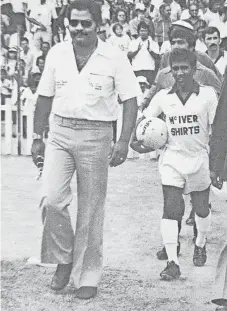  ?? FACEBOOK South African Football History ?? BEREA FC manager Don Mudaly leads his team on to the field at Curries Fountain Stadium for the Coca-cola Shield final against Sundowns in 1976, followed by Duda Moonsamy. |