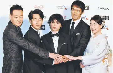  ??  ?? Actors and actress in “KU-KAI, Legend of the Demon Cat,” Lfrom left) Baiqing Xin, Huang Xuan, Shota Sometani, Hiroshi Abe, and Keiko Matsuzaka during the opening ceremony of the 30th Tokyo Internatio­nal Film Festival. — AFP photo