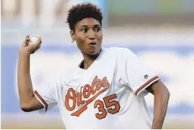  ?? JULIO CORTEZ/AP ?? Angel McCoughtry throws a ceremonial pitch prior to an Orioles game.