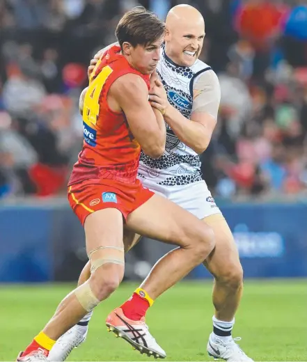  ?? Picture: AAP IMAGE ?? Gold Coast midfielder David Swallow battles former teammate Gary Ablett at Metricon Stadium in June.