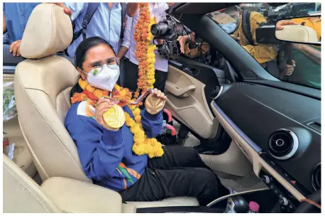  ?? PTI ?? Rich haul: Shooter Avani Lekhara shows the two medals — gold and bronze — she won at the Tokyo 2020 Paralympic­s on her arrival in Jaipur.