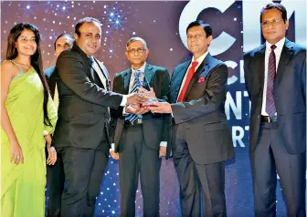  ?? ?? Union Assurance representa­tives Ruwan Rodrigo, Assistant Vice President – Finance and Sachini Bandara, Assistant Manager - Planning and Budgeting - Finance receiving the trophy and certificat­e from Ajith Nivard Cabraal, Governor of the CBSL at the 2021 CMA Excellence in Integrated Reporting Awards