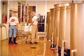  ??  ?? Workers prepare Grapette from a special concentrat­e at the Grapette factory. (Contribute­d)