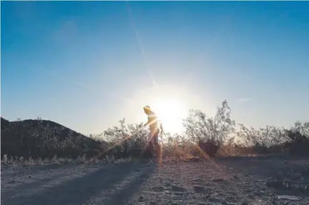  ?? Matt York, The Associated Press ?? A man runs through a section of South Mountain Park at sunrise to avoid the excessive heat in June in Phoenix.