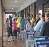  ?? Marie D. de Jesús / Houston Chronicle ?? Kroger customers wait for their turn to enter the Telephone Road store to buy groceries Monday.